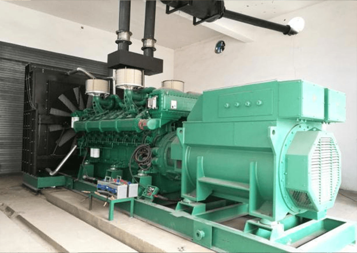 A green 1800 kW genset on a concrete plinth in a plant room, with exhaust ducts rising to the ceiling