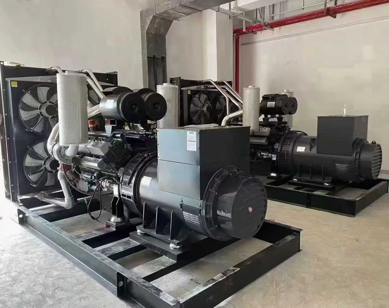 Two 500 kW open-type sets side by side on black skids, each with a large radiator fan and enclosed alternator